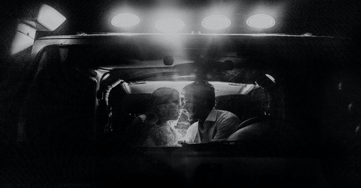 Is there any effect when placing buildings next to each other? - Through car window of couple sitting close to each other in front seat in spotlight