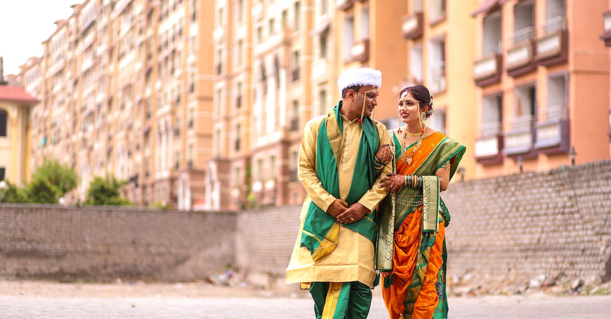 Is there any effect when placing buildings next to each other? - A Couple in Traditional Clothing Walking Together