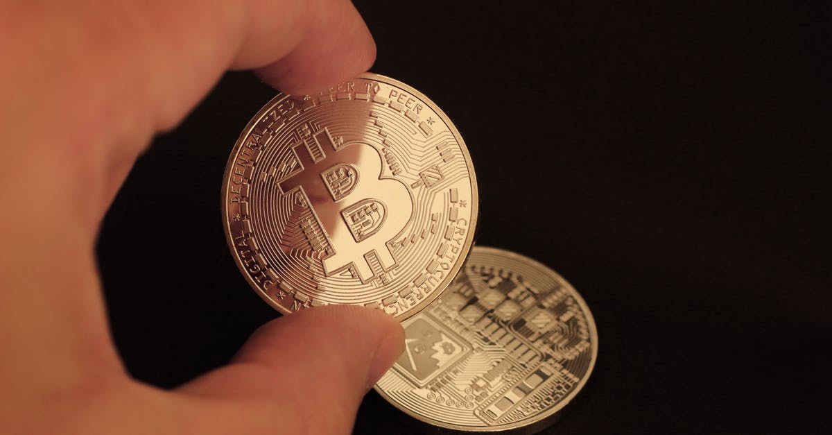 Is there any exchange fee in the gem/gold trade? - Fingers Holding Silver Round Coin