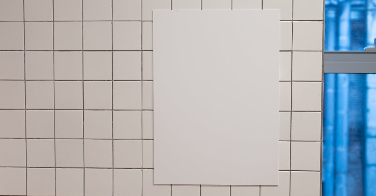 Is there any info on the 1 Feb 2016 Portal 2 Patch? - Blank white placard hanging on wall covered with white tiles inside of building
