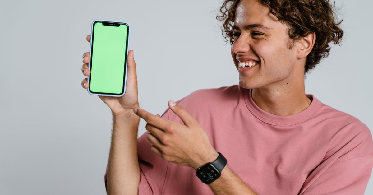 Is there any Institute clothes that allow me to use Armor? - Man in Pink Crew Neck T-shirt Holding Blue Iphone Case