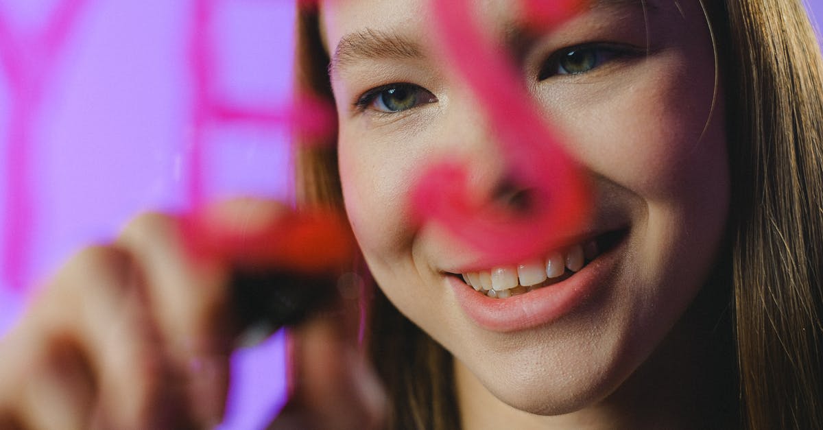 Is there any meaning behind the writing on the wall? - Teenage girl writing Yes on glass