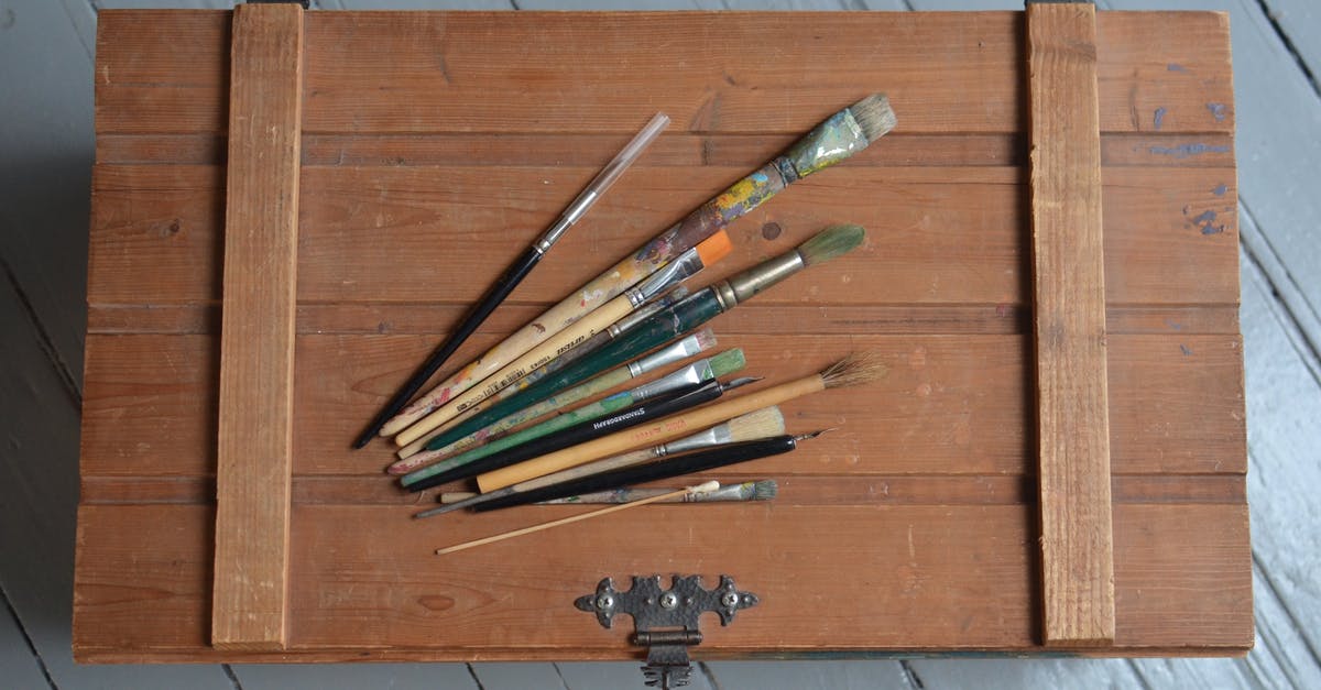 Is there any reason to open a chest from a lower arena as opposed to the same chest from a higher arena? - From above of various brushes placed on old fashioned chest box made of wood on light blue floor