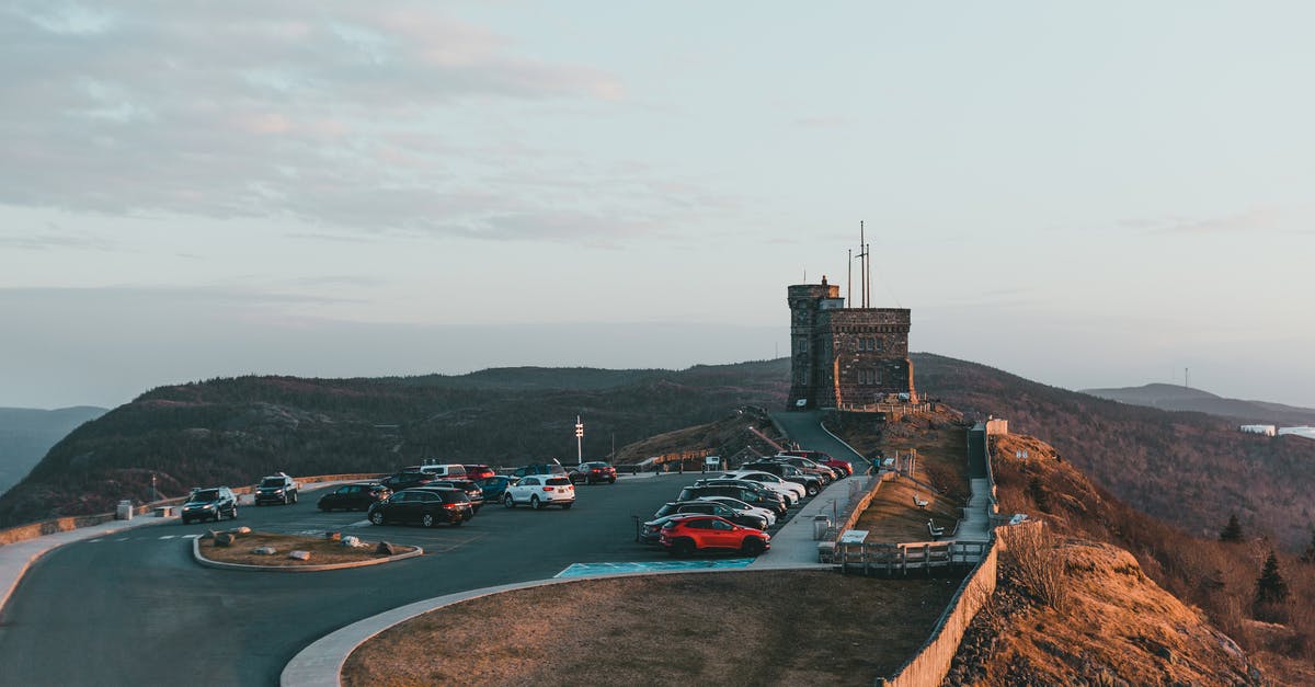 Is there any way I can avoid death by FPS in Dwarf Fortress? - Automobiles parked on asphalt road near famous historic stone fortification located on grassy Signal hill in nature against cloudy sky