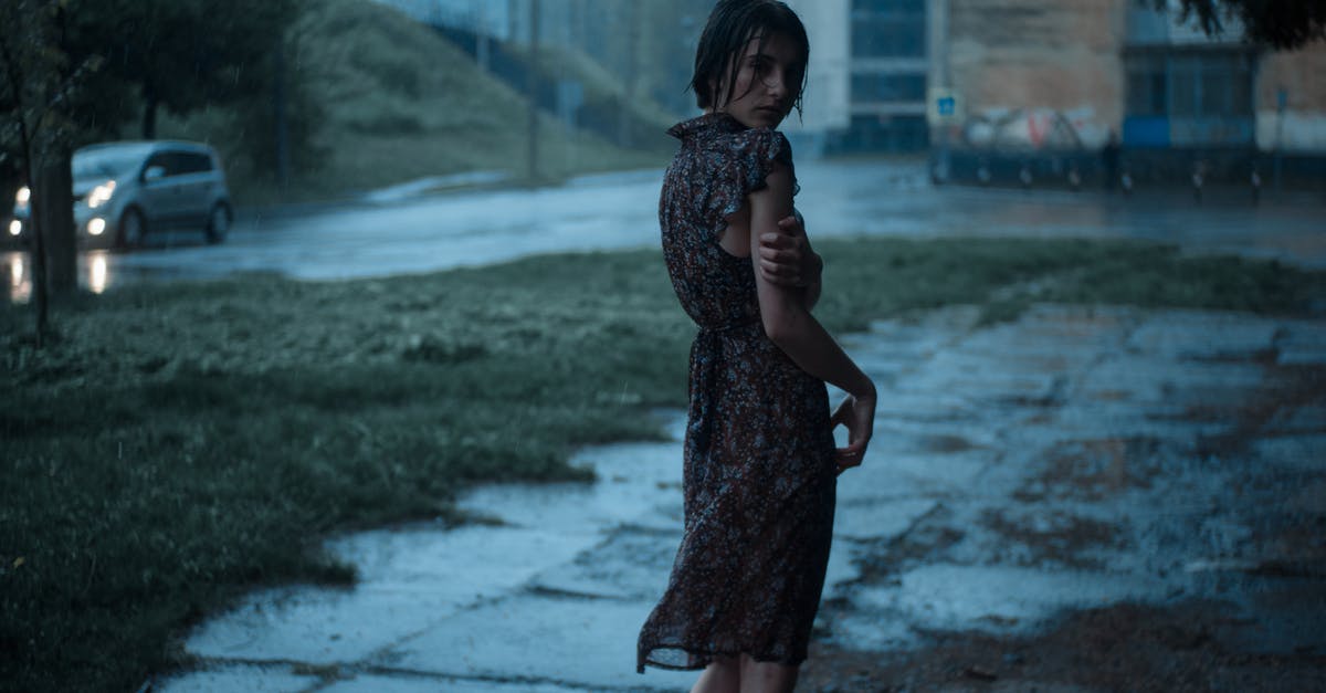 Is there any way I can dress as Bruce Wayne? - Woman standing on street under rain Is there any way I can dress as Bruce Wayne? - Woman standing on street under rain
