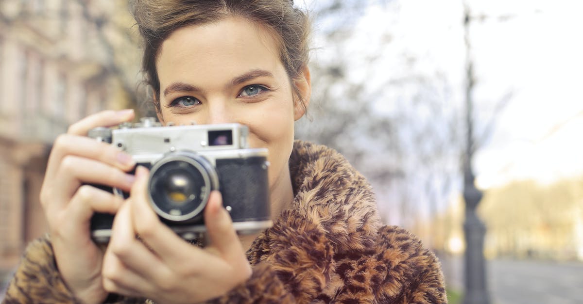 Is there any way to check the Governor's daughters' beauty level? - Woman Holding Black and Gray Camera Focus Photo