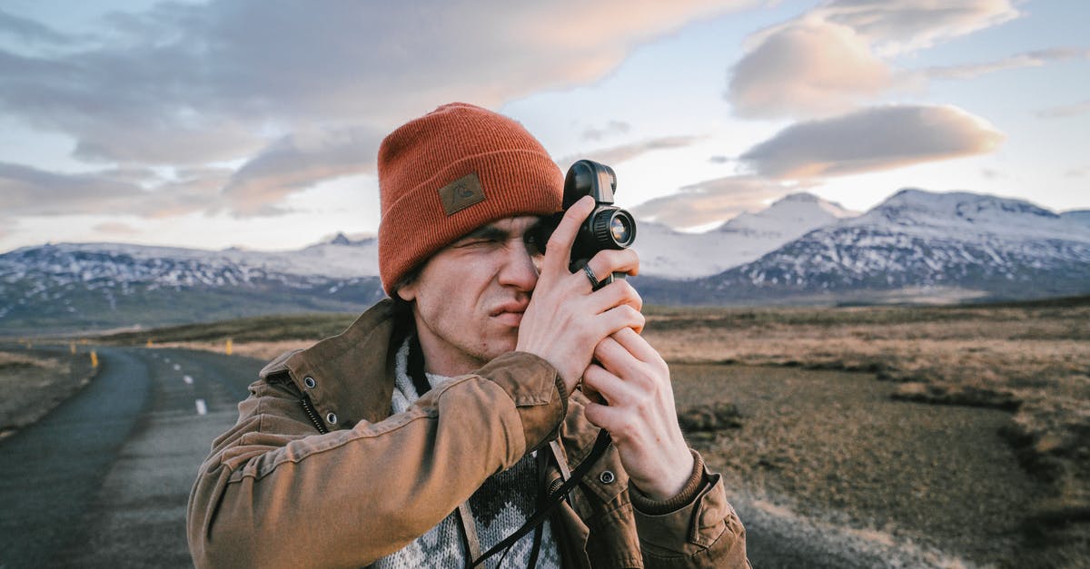Is there any way to deal with helicopter gunships other than shooting them out of the sky? - Male traveler taking photos of valley with mountains