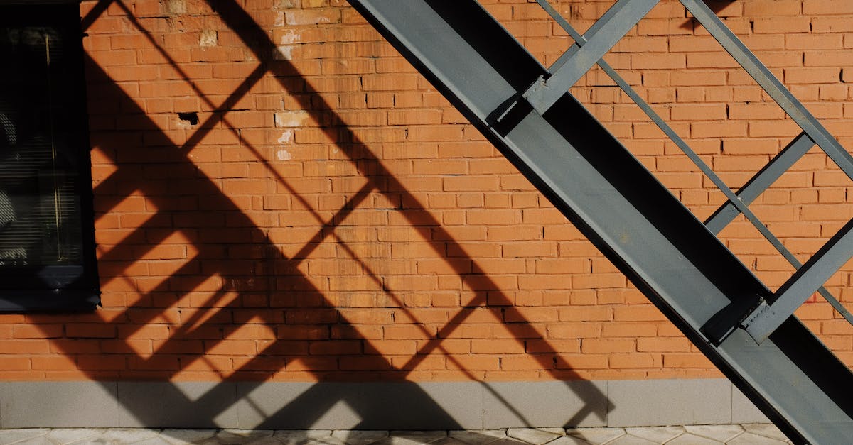 Is there any way to follow the Mr. House questline without killing the Brotherhood of Steel? - Metal staircase near brick wall of modern building in sunny day on street