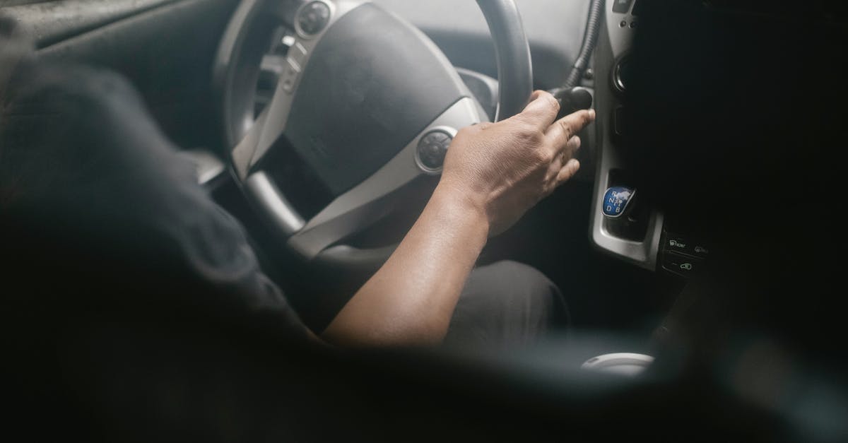 Is there any way to get rid of the 'infinity' button in Cookie Clicker? - High angle of crop unrecognizable male driving modern car on street on sunny day