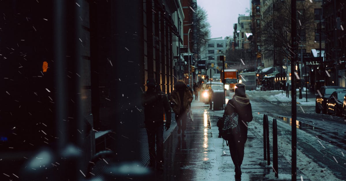 Is there any way to get snow layers to light up properly? - Crowd of people strolling on snowy walkway between road and residential building on street in city during snowfall in winter time