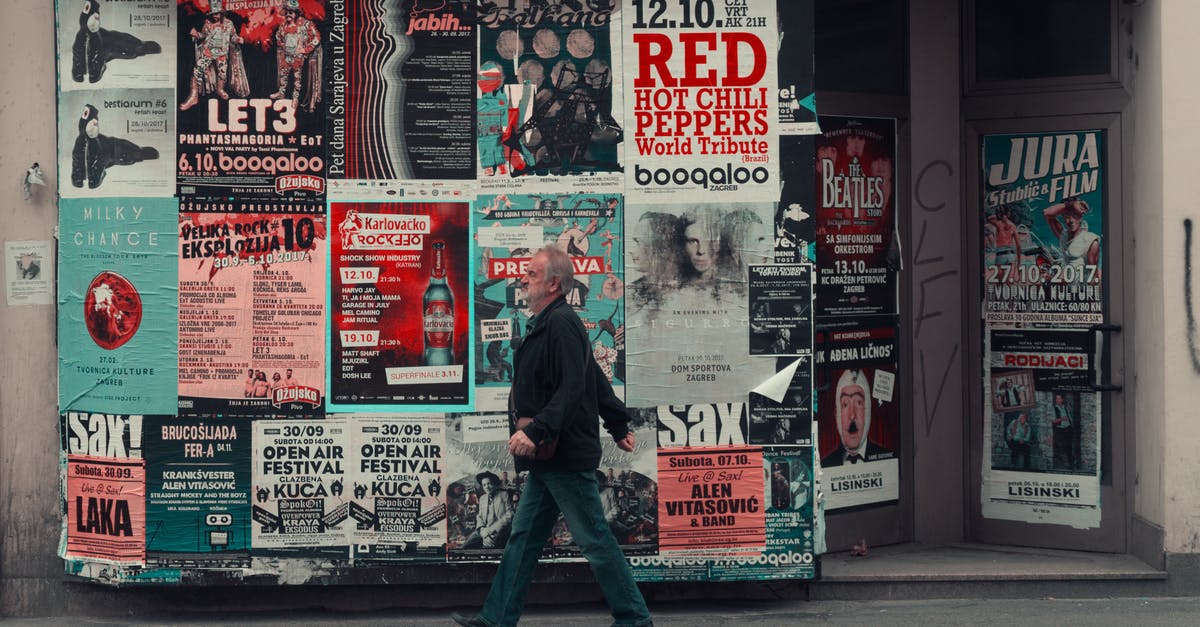 Is there any way to leave an information layer view active while switching to another tool to build? [duplicate] - Side view of senior man in casual clothes walking along wall of modern building with posters while having stroll on city street