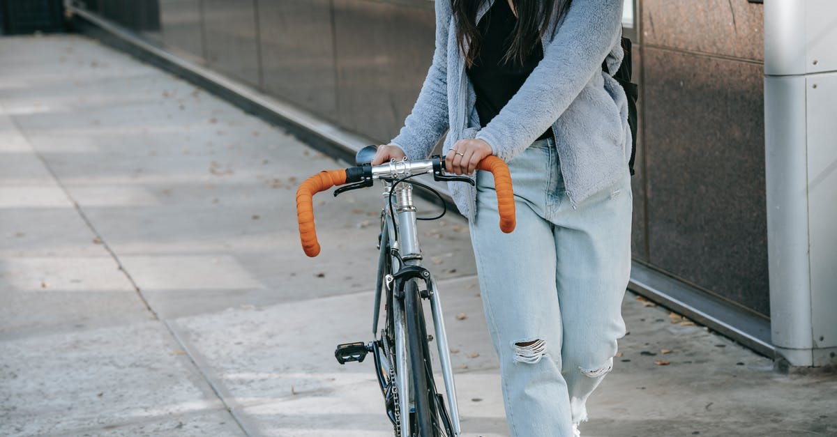 Is there any way to prevent sectors from building on a specific tile of a planet? - Crop woman with bike walking on urban pavement