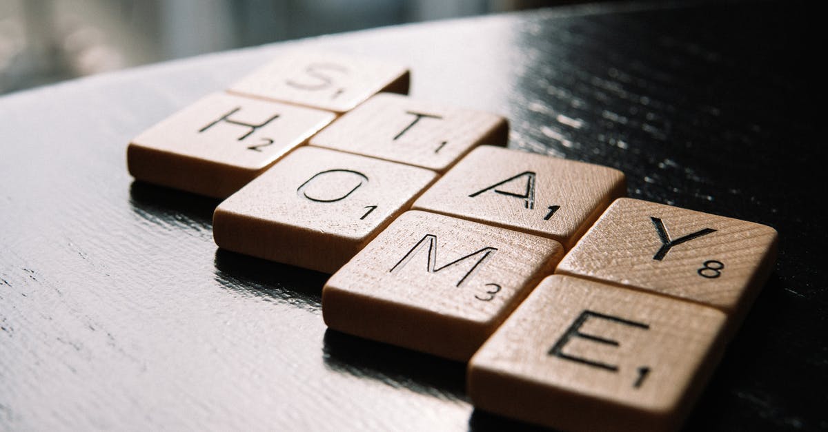 Is there any way to prevent sectors from building on a specific tile of a planet? - High angle of scrabble letter tiles arranged on black wooden table in inscription Stay Home in living room