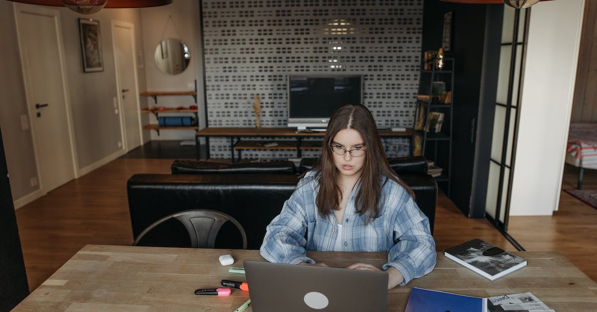 Is there any way to reconnect online without quitting to the menu? - Woman in Blue Denim Jacket Sitting on Chair Using Macbook