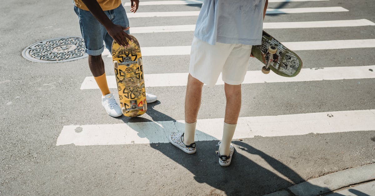 Is there any way to redistribute your skills/perks? - Crop men with skateboards on crosswalk