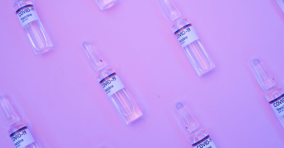 Is there any way to reduce repeated science experiments? - Background of similar ampoules with COVID 19 vaccine placed on table under neon purple light Is there any way to reduce repeated science experiments? - Background of similar ampoules with COVID 19 vaccine placed on table under neon purple light