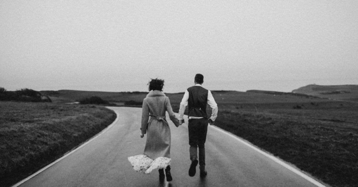 Is there any way to tell if a Pokemon is about to run away or is prone to running away? - Grayscale Photo of Couple Walking on Road