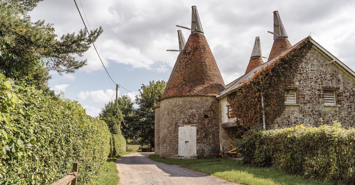 Is there any way with commands, to have 2 Armories on your house? - Shabby stone buildings with towers located near rural path with green bushes in suburban area in countryside on summer day