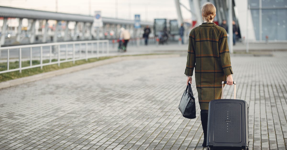 Is there anyway to leave a space station without your ship? - Unrecognizable woman with suitcase walking near airport terminal
