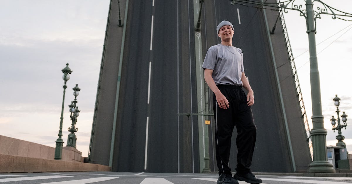 Is there anyway to move Saved Battle Replays off of a 3DS "SD" Card? - Man in White Crew Neck T-shirt and Black Pants Standing Near Gray Building