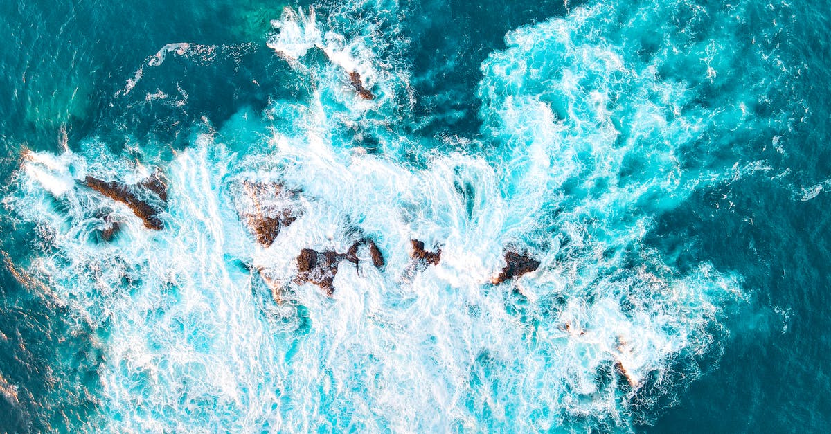 Is there attacking from the sea? - An Aerial Photography of Waves Crashing on a Rock Formation