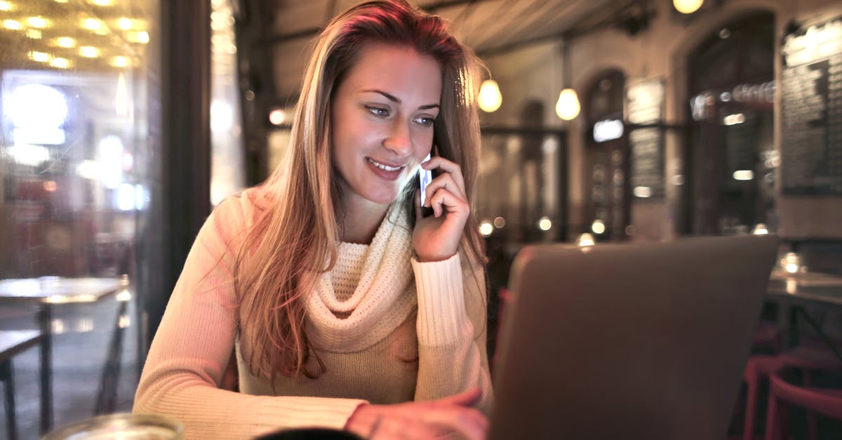 Is there mass phone call in Watch Dogs series? - Content female wearing warm sweater sitting at table in cozy cafe and speaking on cellphone while resting in evening and browsing netbook Is there mass phone call in Watch Dogs series? - Content female wearing warm sweater sitting at table in cozy cafe and speaking on cellphone while resting in evening and browsing netbook