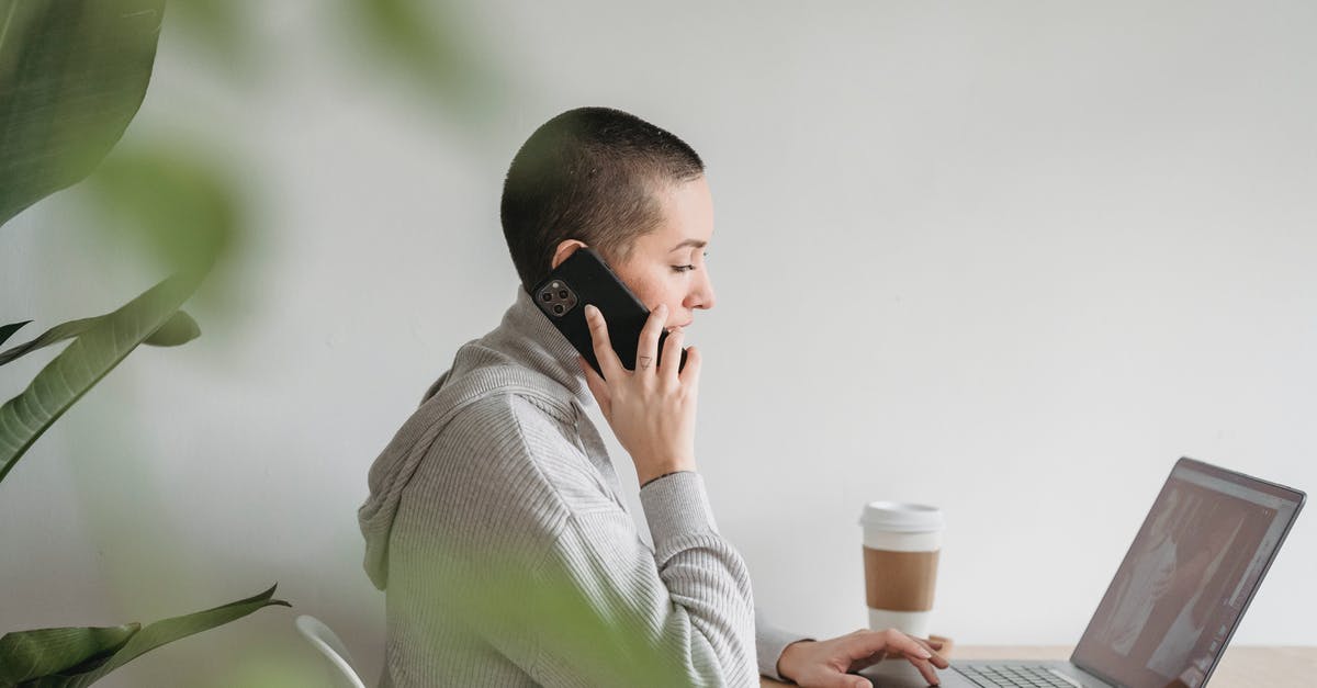 Is there mass phone call in Watch Dogs series? - Woman talking on smartphone and working on laptop at home Is there mass phone call in Watch Dogs series? - Woman talking on smartphone and working on laptop at home