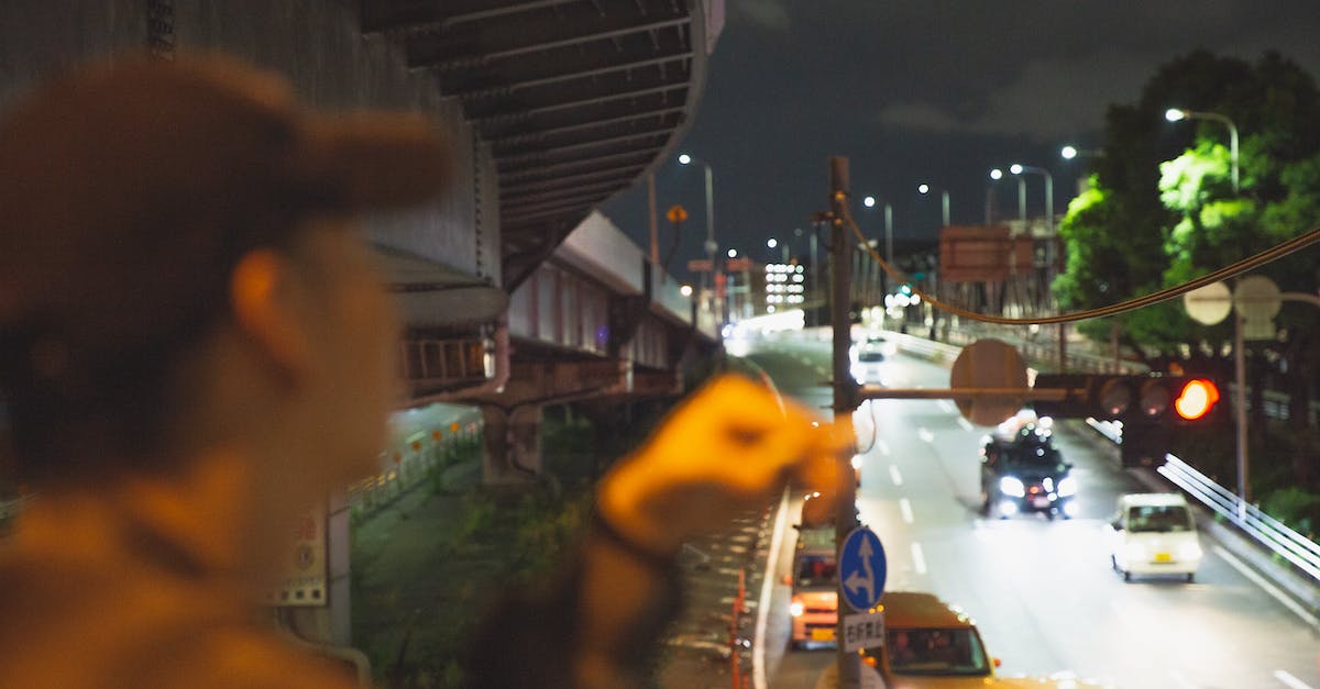 Is upgrading my town hall without upgrading defenses a bad idea? - Man smoking and looking at traffic in city