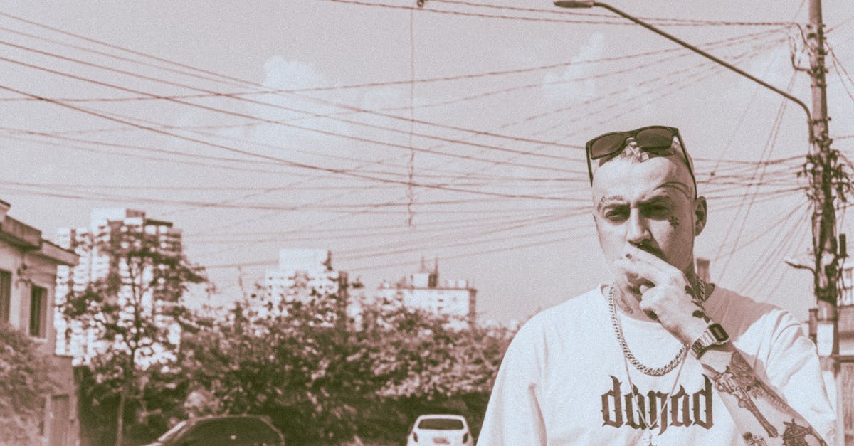 Is upgrading my town hall without upgrading defenses a bad idea? - Confident tattooed man smoking on street