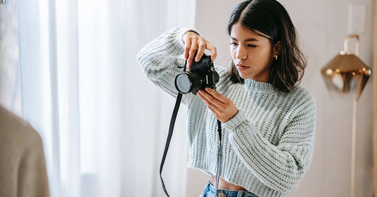 Is using decor considered as glitching for the purposes of a Speedrun? - Serious young Hispanic woman in casual outfit taking photos on photo camera while standing at bright home near window with curtains Is using decor considered as glitching for the purposes of a Speedrun? - Serious young Hispanic woman in casual outfit taking photos on photo camera while standing at bright home near window with curtains