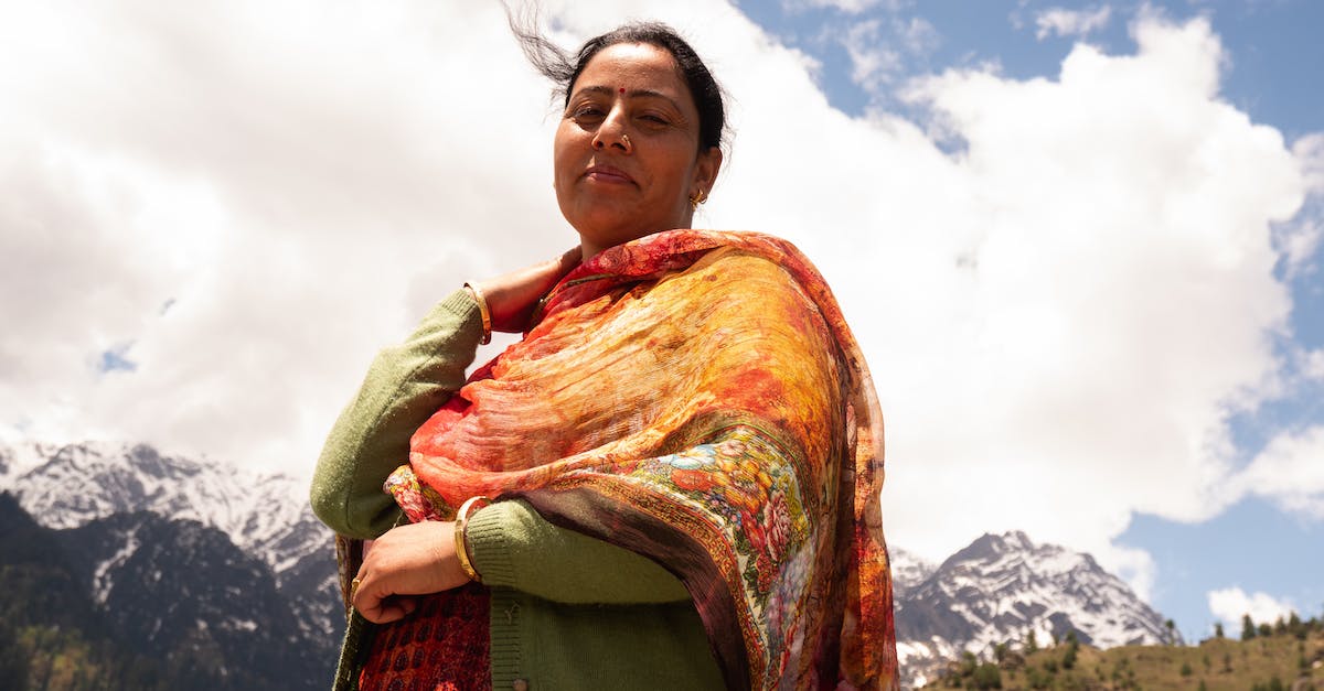 Is your vault saved locally or in the cloud? - Positive ethnic female resting in village near mountains Is your vault saved locally or in the cloud? - Positive ethnic female resting in village near mountains
