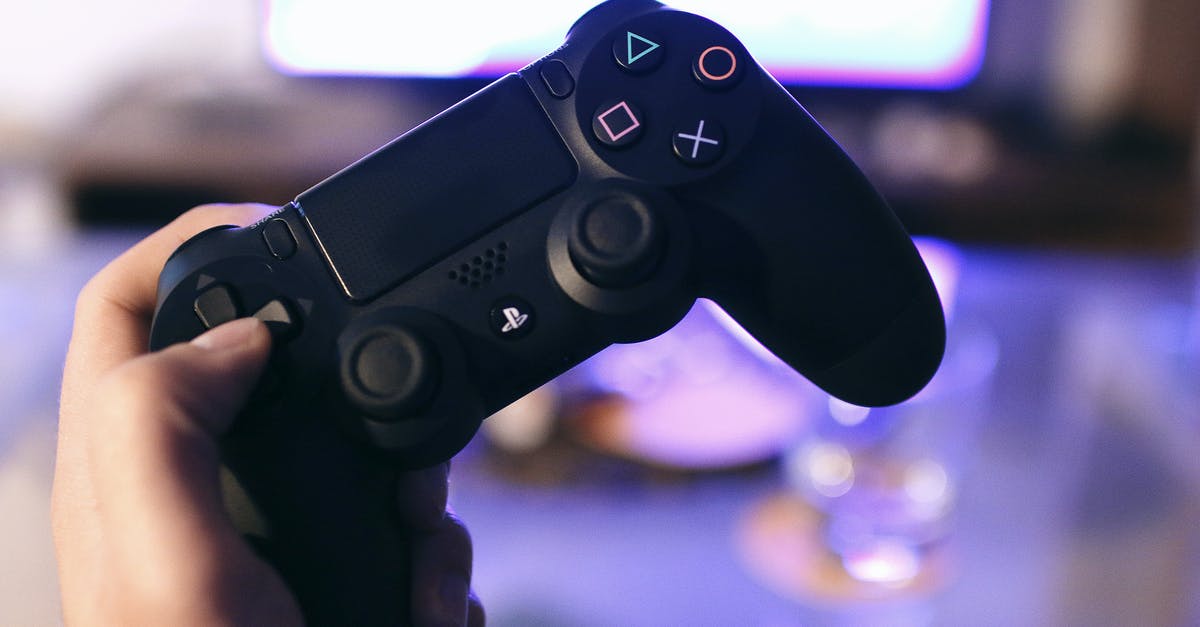 Issues reconnecting PS4 controller to console after using iPad - Person Holding Sony Ps4 Dualshock 4