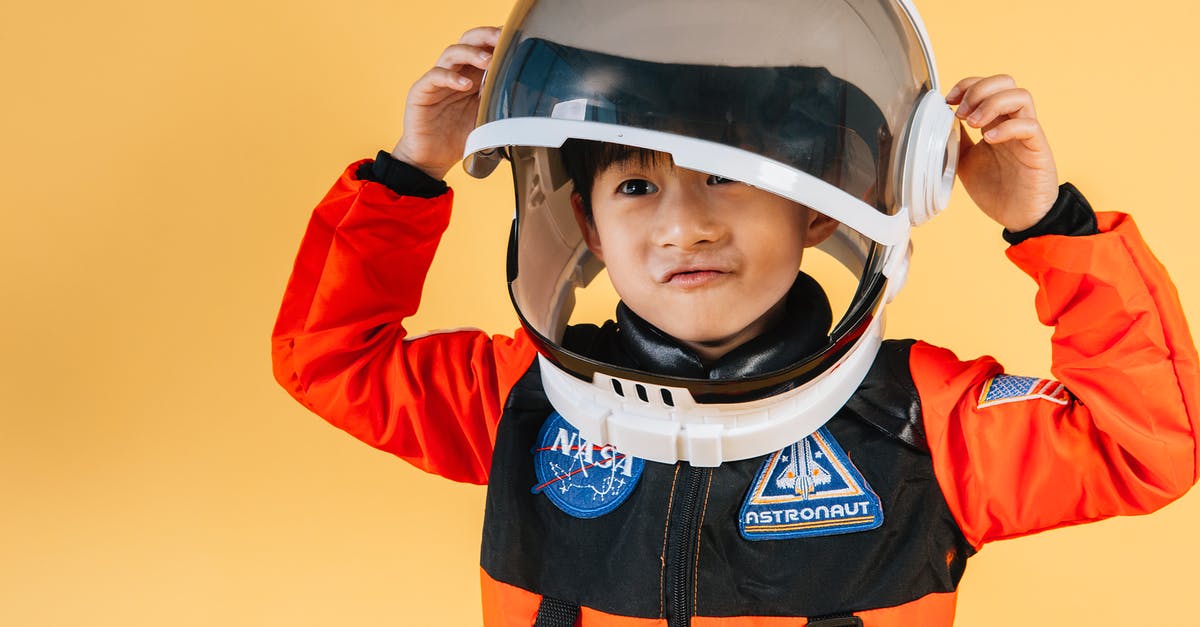 Issues Unlocking the Dream Suit - Positive Asian kid wearing cosmonaut helmet Issues Unlocking the Dream Suit - Positive Asian kid wearing cosmonaut helmet