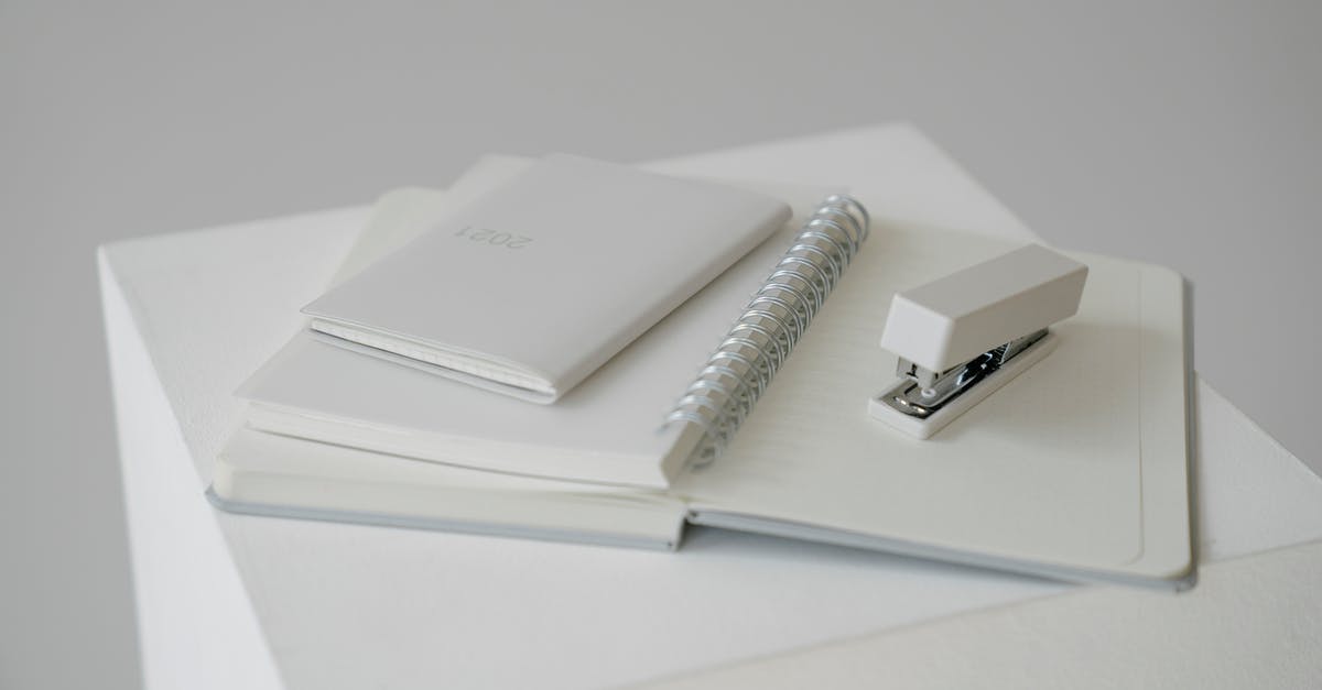 Kanai's Cube powers and other legendary items - Notepad with stapler and diary with planner on white cube Kanai's Cube powers and other legendary items - Notepad with stapler and diary with planner on white cube