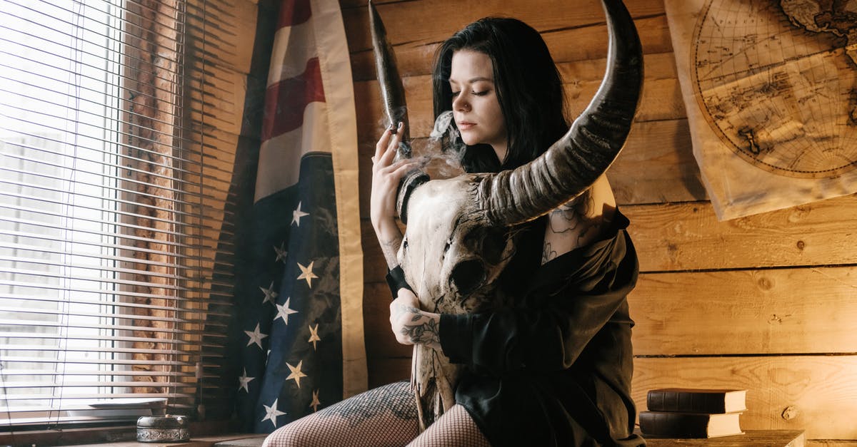 Kill a mob without death animation? - Young female smoking cigarette and embracing big horned animal skull Kill a mob without death animation? - Young female smoking cigarette and embracing big horned animal skull