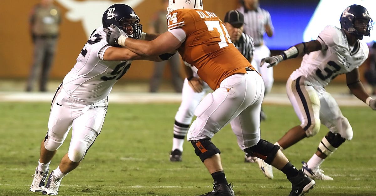 Knock a player off of a block - Men Running Playing Football during Daytime Knock a player off of a block - Men Running Playing Football during Daytime
