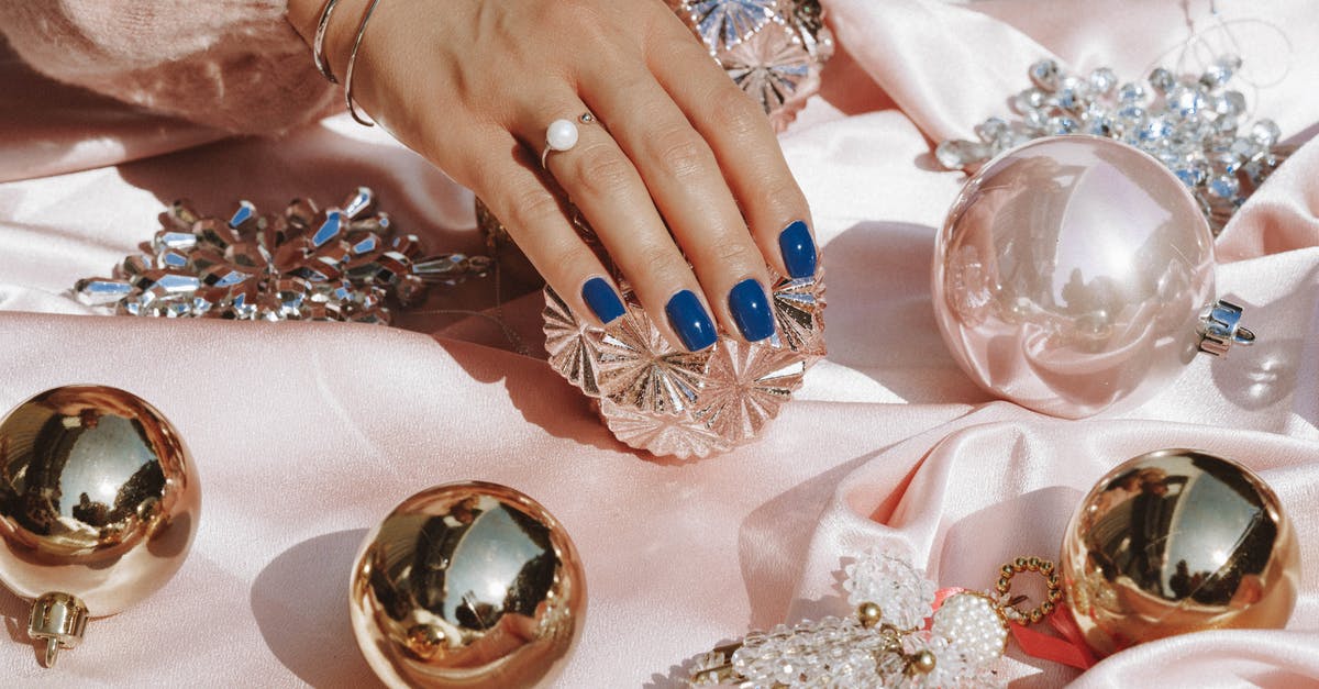 Laying Lophids Low - Person Wearing Gold Ring and Blue Manicure Laying Lophids Low - Person Wearing Gold Ring and Blue Manicure