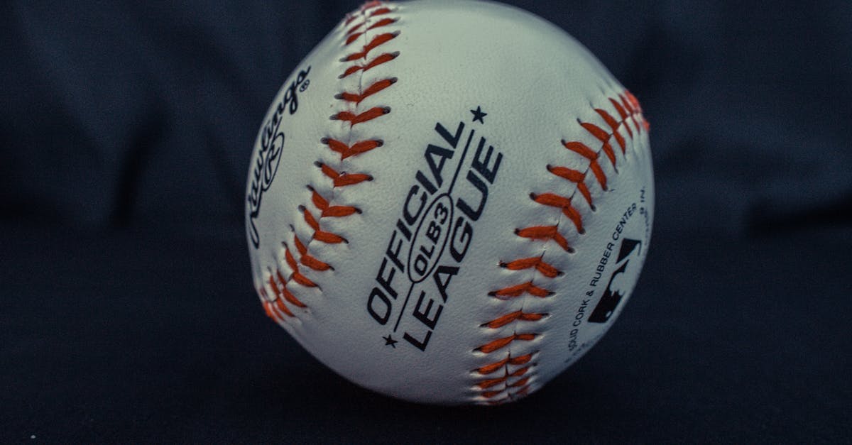 League of Legends genre [closed] - White and Orange Official League Baseball on Black Textile
