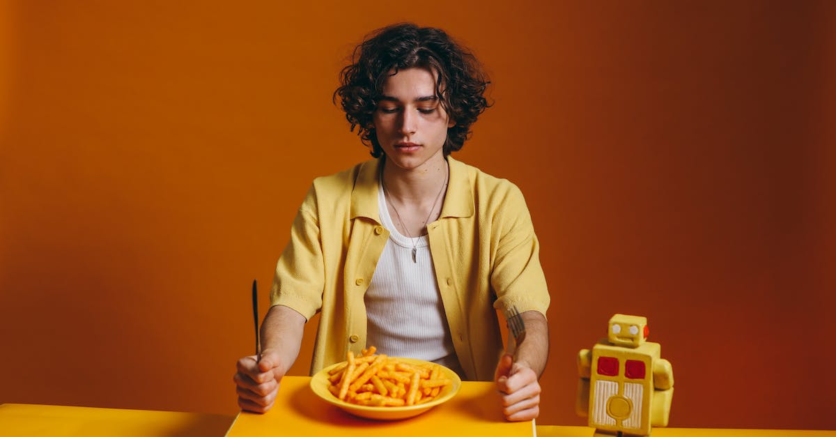 Lego game with a trashcan eating robot - Young Man Looking Down On A Plate Of Fries Lego game with a trashcan eating robot - Young Man Looking Down On A Plate Of Fries