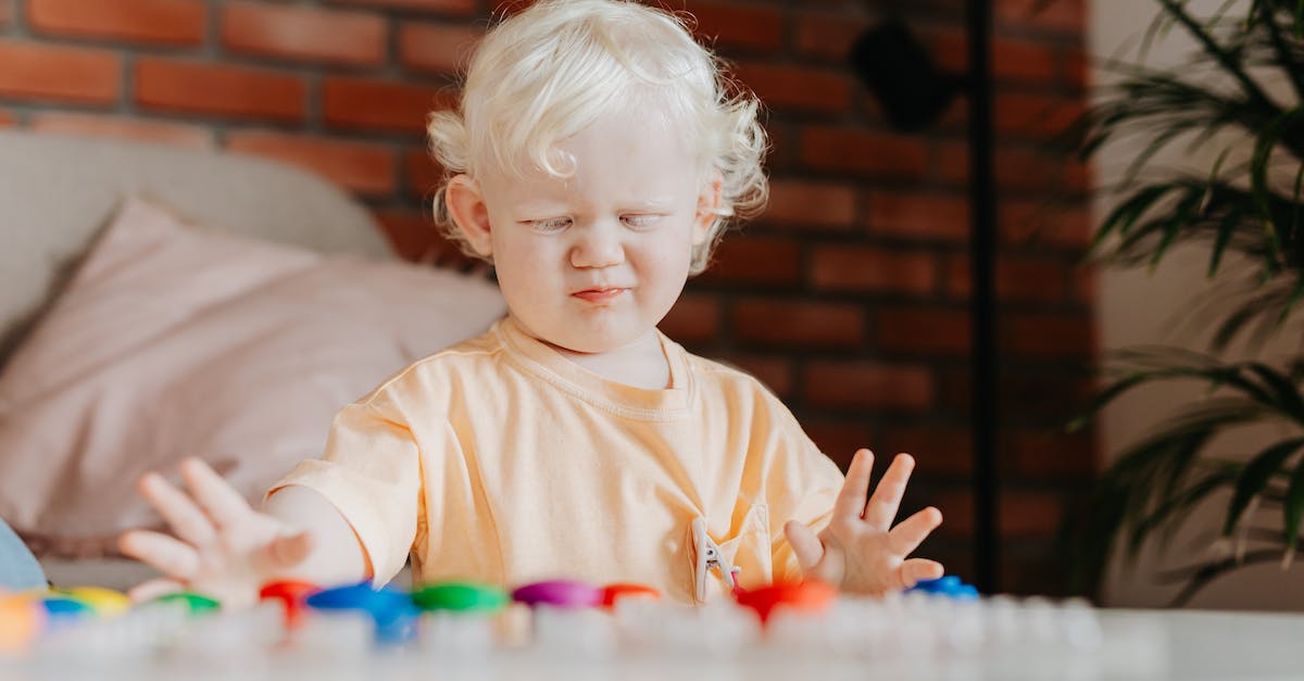 Leveling up in solo-play? - Child in White Crew Neck Shirt Playing With Lego Blocks Leveling up in solo-play? - Child in White Crew Neck Shirt Playing With Lego Blocks