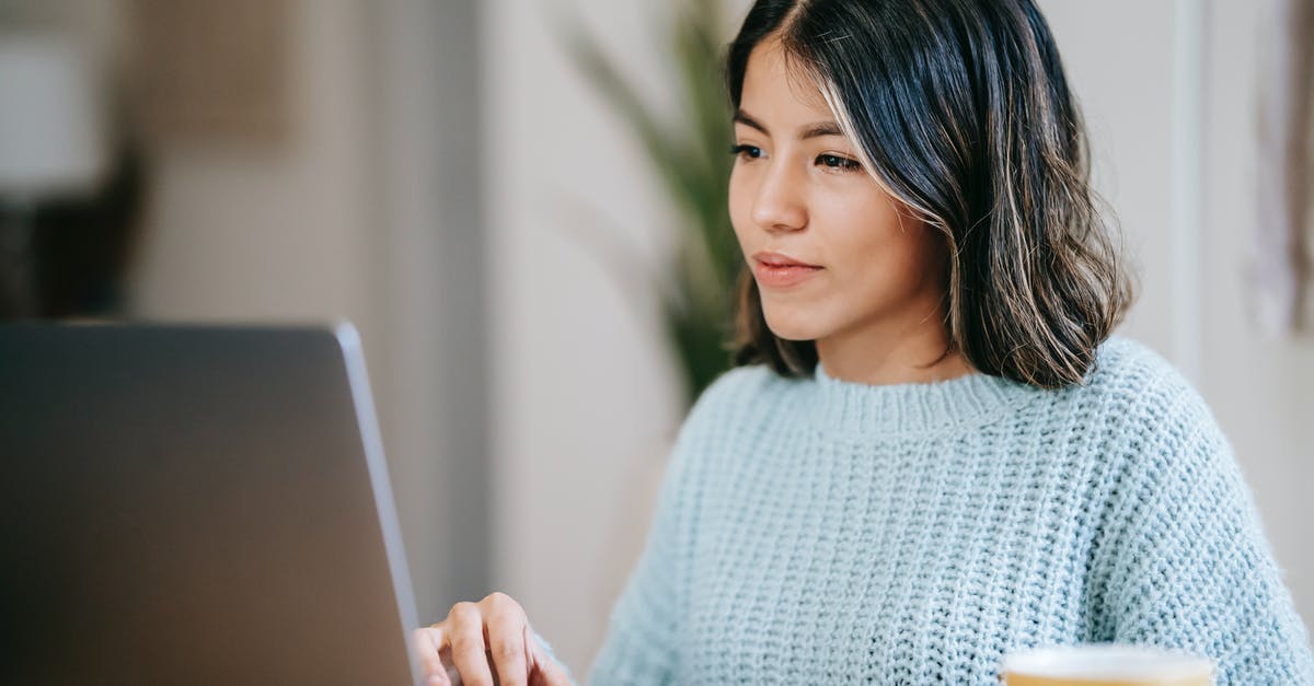 Light armor for more independent adventuring? - Confident young Latin American woman in casual clothes working remotely on netbook at table near mug with coffee in light apartment with plant with green leaves near wall