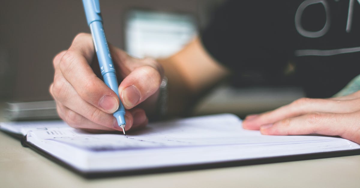 List of unlocked artifact rewards - Person Holding Blue Ballpoint Pen Writing in Notebook List of unlocked artifact rewards - Person Holding Blue Ballpoint Pen Writing in Notebook