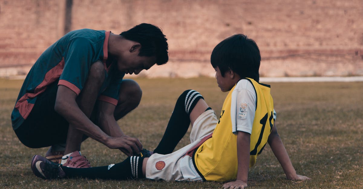 Load certain entities only when a player is near - 2 Men in Red and White Jersey Shirt Sitting on Grass Field