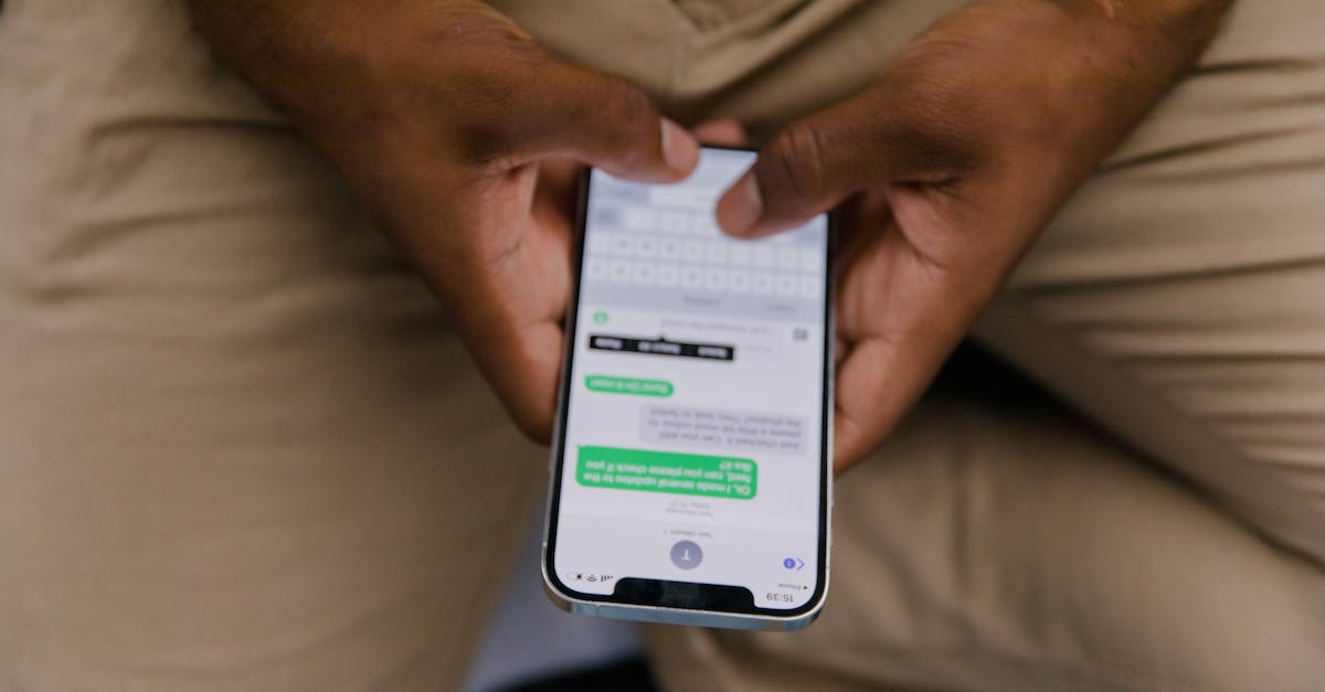 Loading screen messages - Close-Up View of Man Texting on Phone
