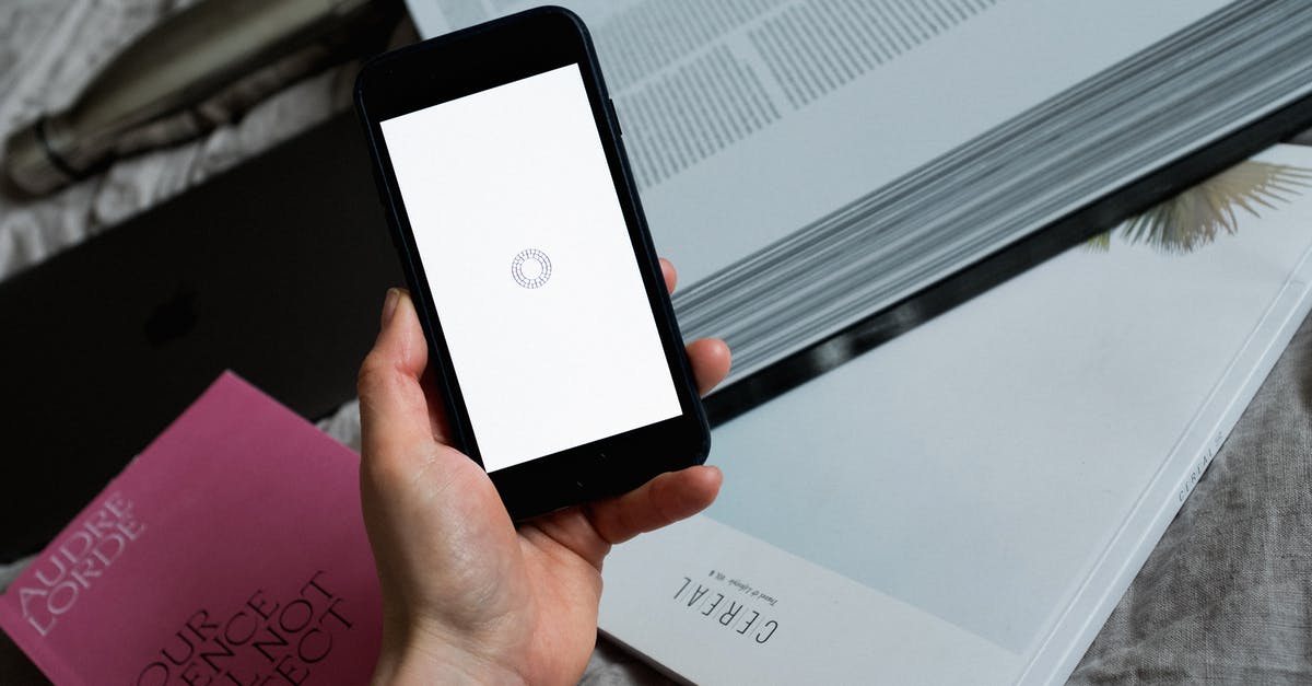 Loading screen messages - Crop unrecognizable person with smartphone showing load logo on screen Loading screen messages - Crop unrecognizable person with smartphone showing load logo on screen