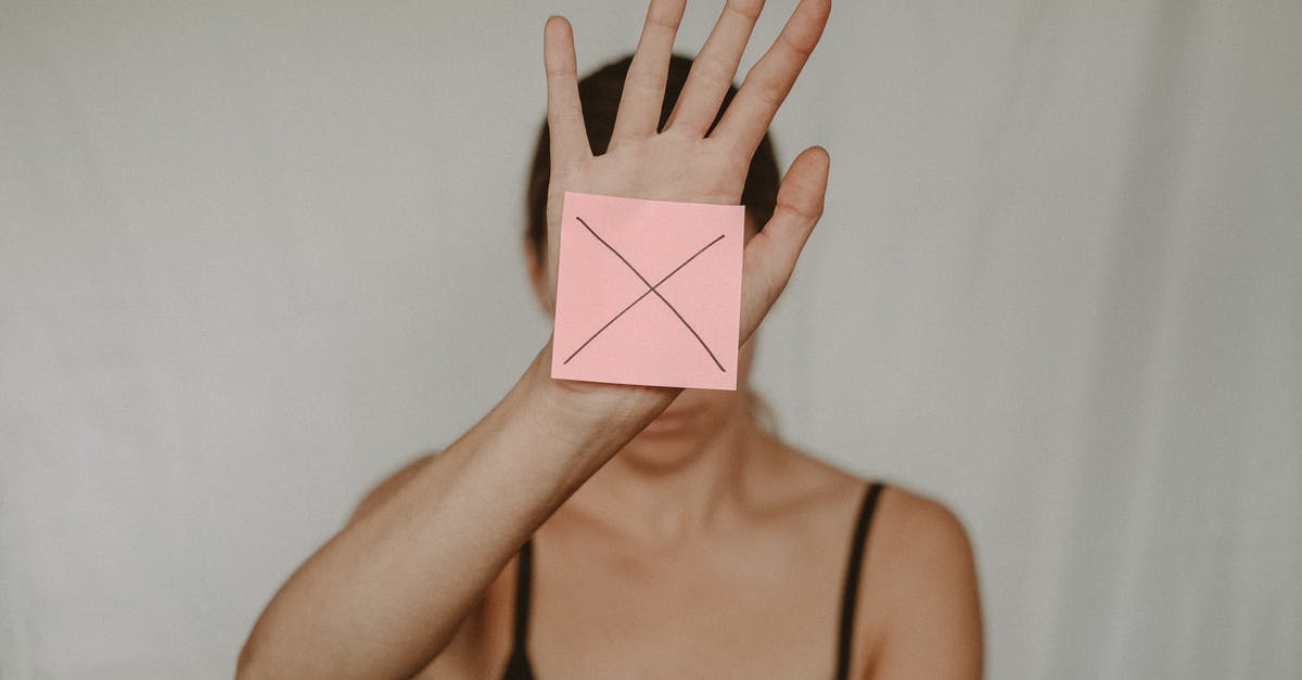 Loading (sign out) problem - Unrecognizable young woman demonstrating prohibition sign showing gesture of refuse using hand and note with sign stop Loading (sign out) problem - Unrecognizable young woman demonstrating prohibition sign showing gesture of refuse using hand and note with sign stop