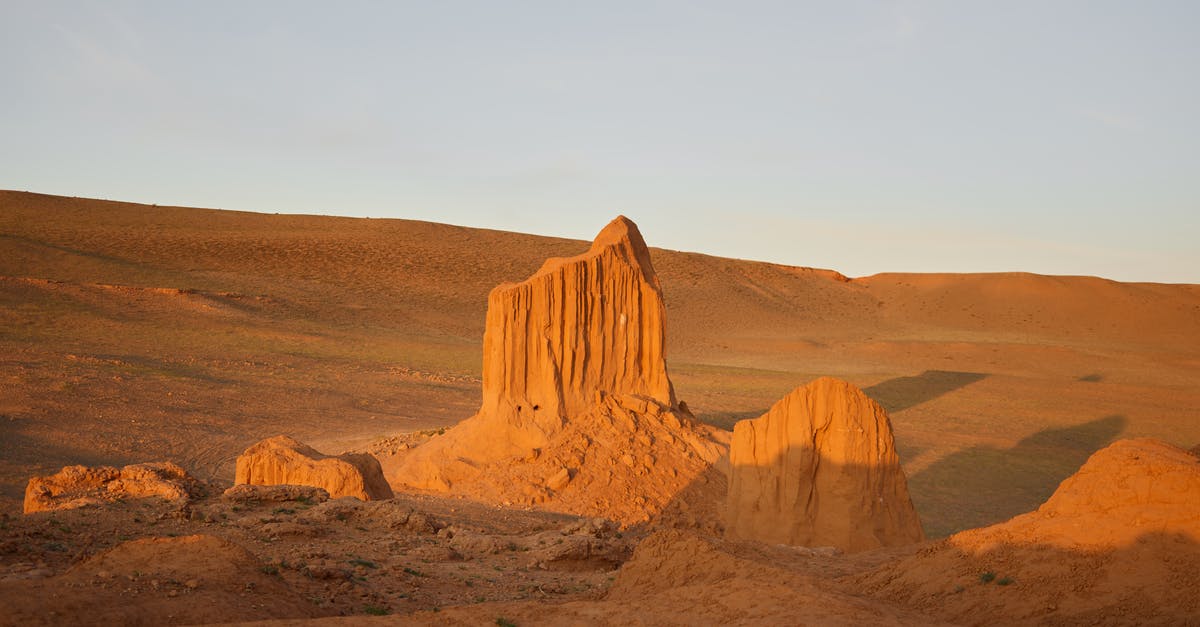 Locating server for too long - Desert landscape with rocky mountains under clear blue sky