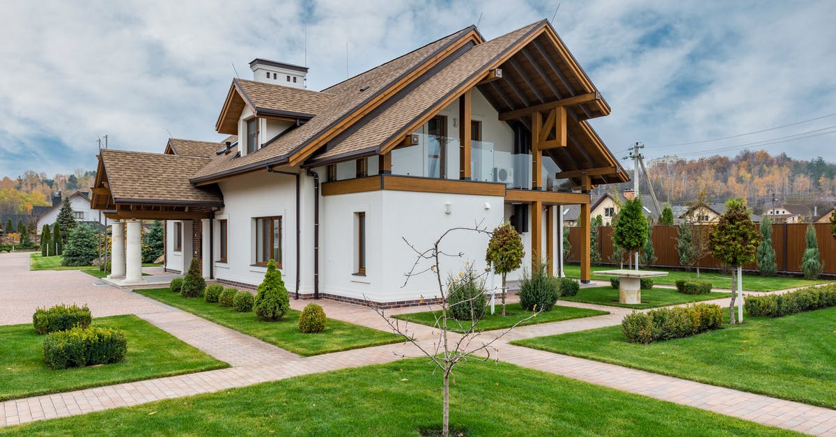 Location glitching - Exterior of modern cottage house with columns and balcony surrounded by green grass and trees Location glitching - Exterior of modern cottage house with columns and balcony surrounded by green grass and trees