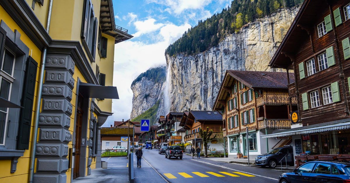 Locked myself out at the waterfall location - Asphalt road among modern cottages near mountains with waterfall