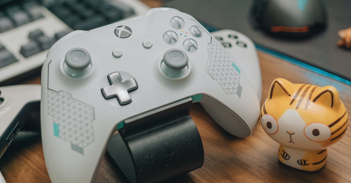 Locking the mouse cursor to an Xbox 360 controller, on OS X - White Xbox Controller on Brown Wooden Surface
